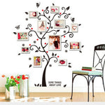 Wall decal of a decorative tree with photo frames and 'Some Things About Love' text, placed in a room with a chair and flowers.