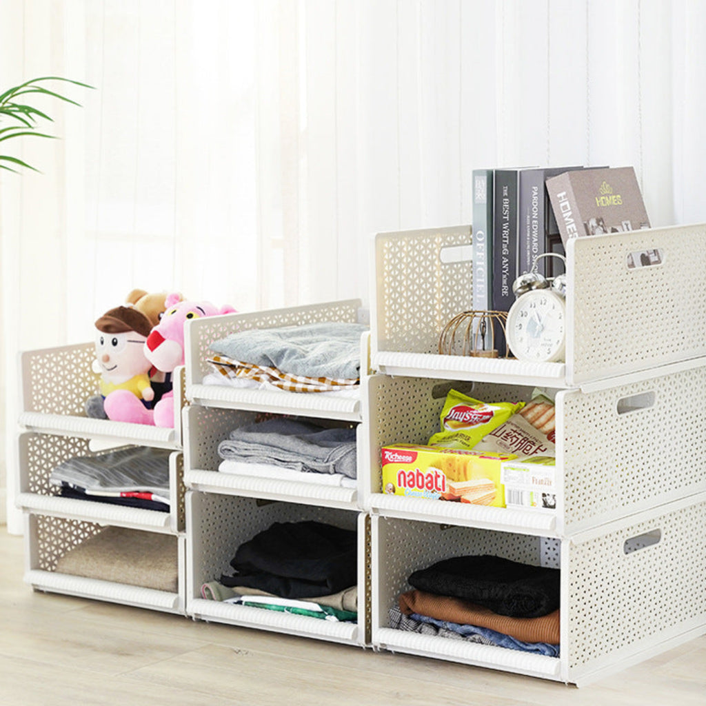 White storage cubes with various items on a light wooden floor.