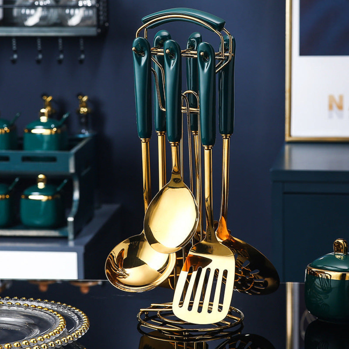 Set of gold and green kitchen utensils on a dark surface with a kitchen background.