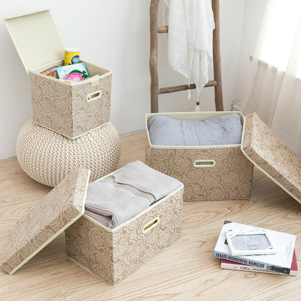Patterned storage bins on a wooden floor with books and clothes inside.