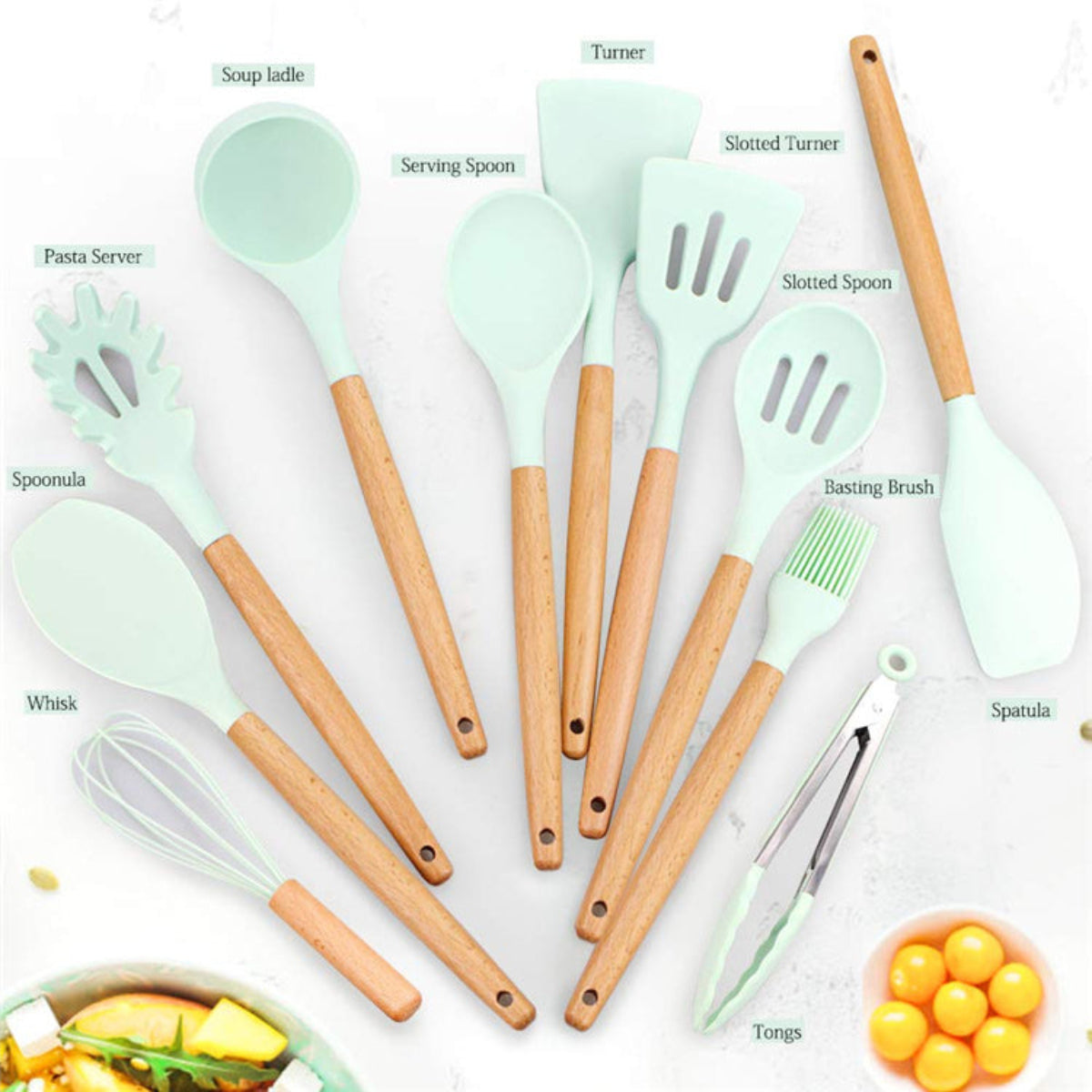 Set of kitchen utensils with wooden handles and green silicone heads on a white background.